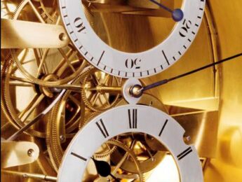 A close up of two clocks with roman numerals
